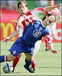 Johann Vogel of Switzerland clashes with Niko Kovac of Croatia in the first Group B match