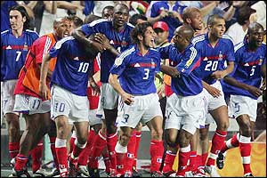 France congratulate Zinedine Zidane after he gives them victory over England in their first game of the competition