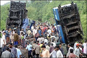 rescuers and survivors throng around upended coaches