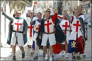 England fans walk through the centre of Coimbra in Portugal before England's match with Switzerland 