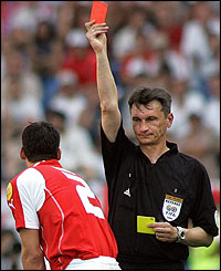Russian referee Valentin Ivanov shows the red card to Bernt Haas