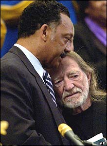 Willie Nelson embraced by the Reverend Jesse Jackson