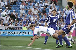 Dmitri Bulykin stoops to head home Russia's second goal