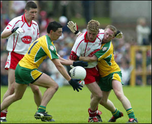 Michael Hegarty beats Kevin Hughes to win possession