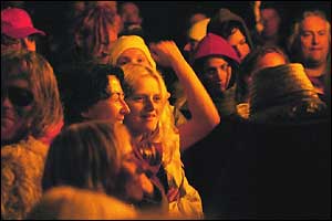 People at Stonehenge with glow of sunlight on their faces