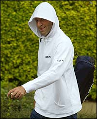Britain's Greg Rusedski manages to smile in the rain