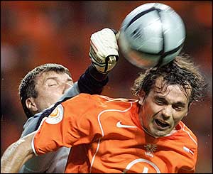 Holland's Philip Cocu forces Kolinko into evasive action in the Latvian goal
