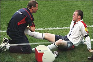 England physio Gary Lewin tends to Rooney's ankle