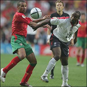Costinha battles Vassell for the ball