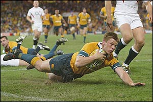 Clyde Rathbone of the Wallabies dives over for a try 