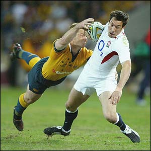 England wing Tom Voyce is tackled by Clyde Rathbone in a lively match