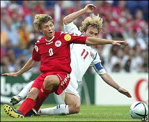 Jon Dahl Tomasson of Denmark is tackled by Pavel Nedved