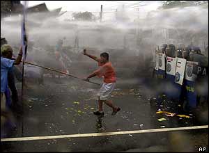 Poe supporters clash with riot police in a Manila suburb on the eve of the inauguration