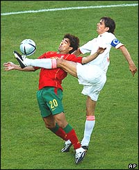 Deco of Portugal controls the ball ahead of Phillip Cocu
