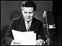 Richard Baker reading the news