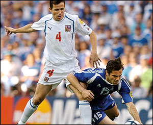 Zisis Vryzas is tackled by Tomas Galasek 