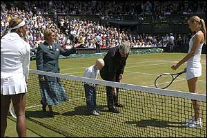 Five year old Emily Bailes from Walsall in the West Midlands performs the coin toss to decide who will serve first