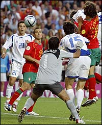 Charisteas rises above the Portugal defence to head Greece into a shock lead