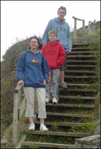 Kate, Toby and Ben on the steps near the costal path in Llantwit Major (John Parker, Cardiff)