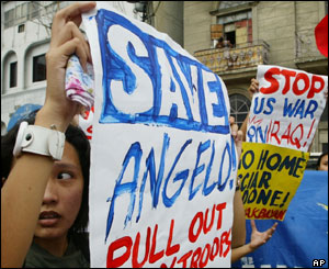Protesters display placards during a rally near the US Embassy in Manila, 15 July