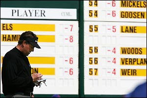 Phil Mickelson of the USA marks down his score at the first