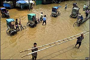 Rickshaws go through floodwaters in Gauhati