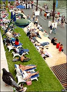 People wander the bank of the Seine in Paris, as the third Paris Plage is inaugurated 