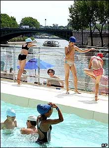 Children play in a pool at the Paris beach installation along the River Seine 