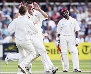 England's spin bowler Ashley Giles enjoys taking the wicket of Brian Lara as England take charge