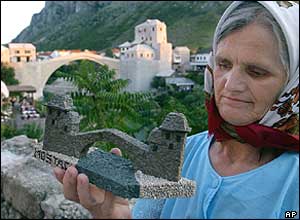 A Bosnian Muslim woman with a handmade replica of the bridge 