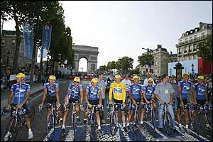 Lance Armstrong and US Postal team-mates pose in front of the Arc de Triomphe after Lance's fourth Tour de France victory