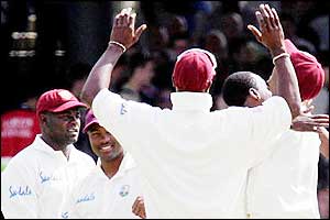 The West Indies team celebrate a good start to day four as they claim three quick wickets