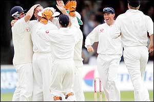 England players congratulate Giles on the early wicket of Devon Smith