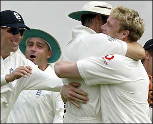 Andrew Flintoff is hugged by captain Michael Vaughan as Lara goes for 95 with West Indies on 221-3