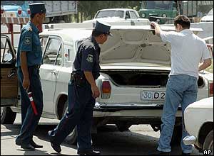 Police officers check a car in the Uzbek capital Tashkent