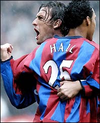 Tony Popovic celebrates with Fitz Hall as the bottom-placed team get off to a great start