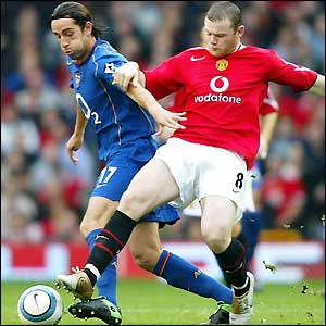 Wayne Rooney attempts to deprive Edu of the ball