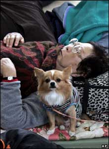 An elderly woman takes a rest with her pet dog in an evacuation centre in Nagaoka, northwest of Tokyo, Monday, Oct. 25, 2004. 