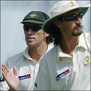 Jason Gillespie and Glenn McGrath head off the pitch after a job well-done