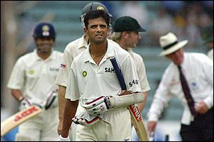 Rahul Dravid leaves the ground after play was stopped by rain at the Wankhede Stadium