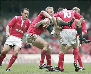Stephen Jones of Wales tackles Marius Joubert of South Africa