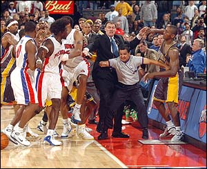 Indiana's Ron Artest and Ben Wallace (pictured wearing number three) and forced apart after becoming involved in a scuffle