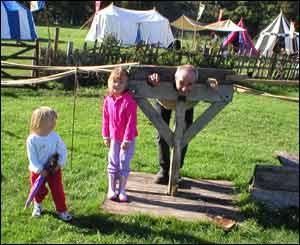 Tony Monger sent in this picture of himself, after he had been put in the stocks at Cosmeston Medieval Village by his granddaughters Sophie and Olivia