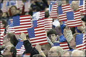 Fans hold up the Stars and Stripes to mark Thanksgiving Day