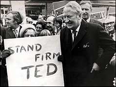 Edward Heath and campaigner holding stand firm Ted poster