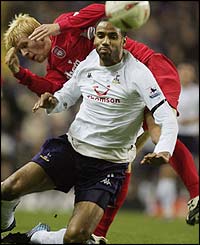 Frederic Kanoute is challenged by Liverpool's Zak Whitbread