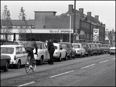 Queue of cars outside petrol station in London - 1973