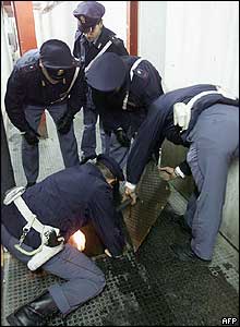 Police search a sewer