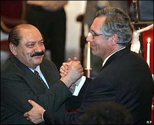 Senate leader Hormando Vaca Diez (left) shakes hands with new President Eduardo Rodriguez 