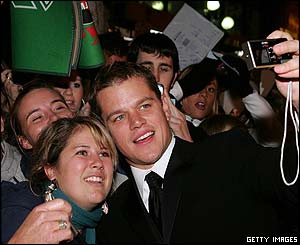 Matt Damon (right) poses with a fan